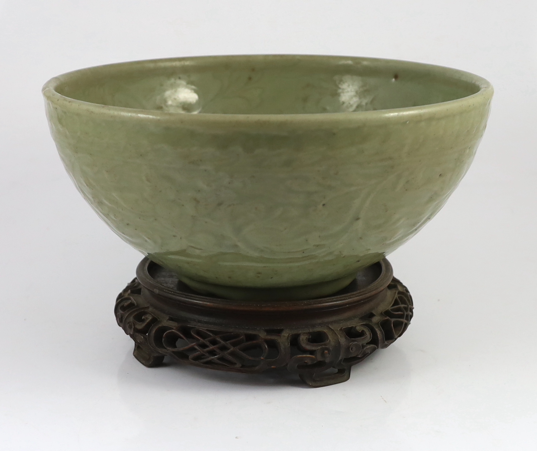 A large Chinese Ming carved Longquan celadon deep bowl, first half 15th century, scratches to glaze